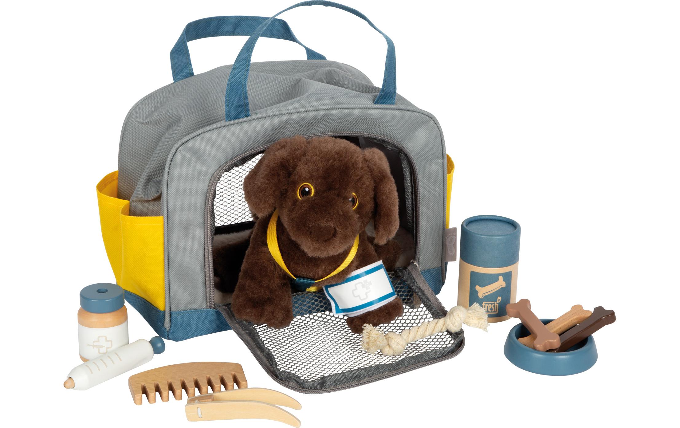 Hund mit Tasche und Pflege-Set